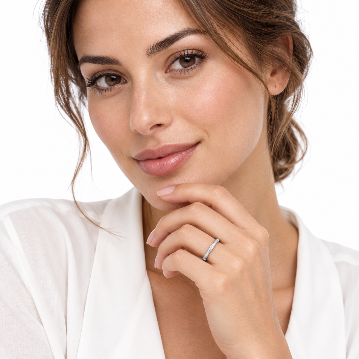 Model wearing the delicate Sasa bamboo ring on a crisp white background