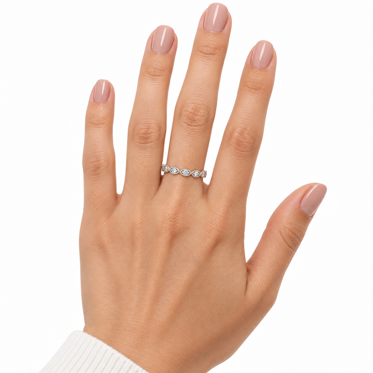 Bryn ring worn on a hand with nude pink nails against white