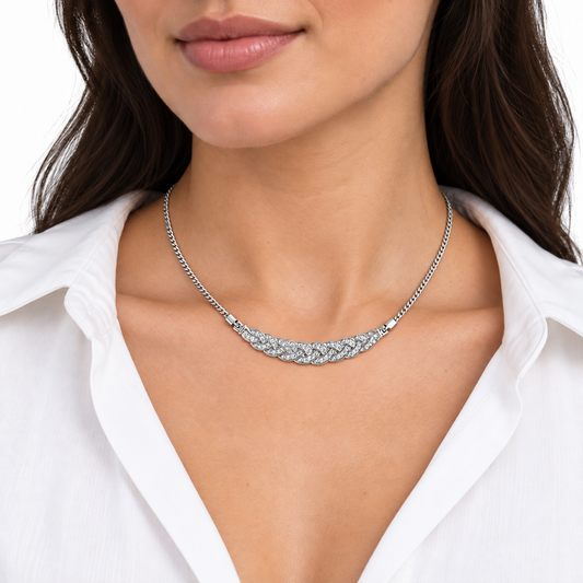 Model wearing the Ivy silver plaited necklace at a delicate scale with a white shirt against a white background.