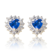 Load image into Gallery viewer, A beautiful tribute to the heart. Delicate rhodium plated studs with clear cubic zirconia stones framing a subtle blue heart stone at the centre. For pierced ears. Side view (Butterfly and pole closure)
