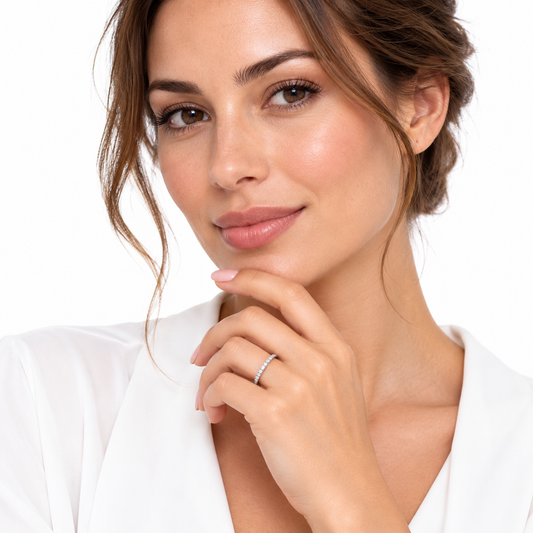Model wearing the delicate Esme eternity ring on a crisp white background