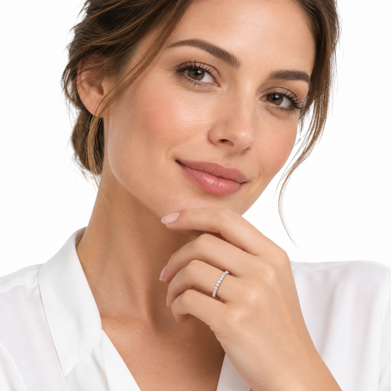 Model wearing the delicate Essa eternity ring on a crisp white background