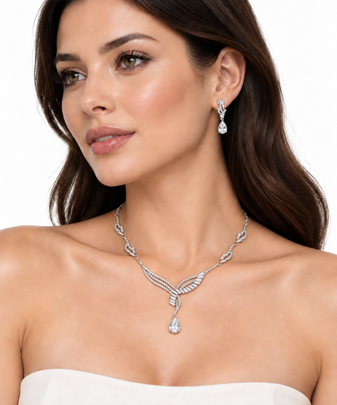 Model wearing the Beaumont silver pear cut necklace and matching drop earrings on white