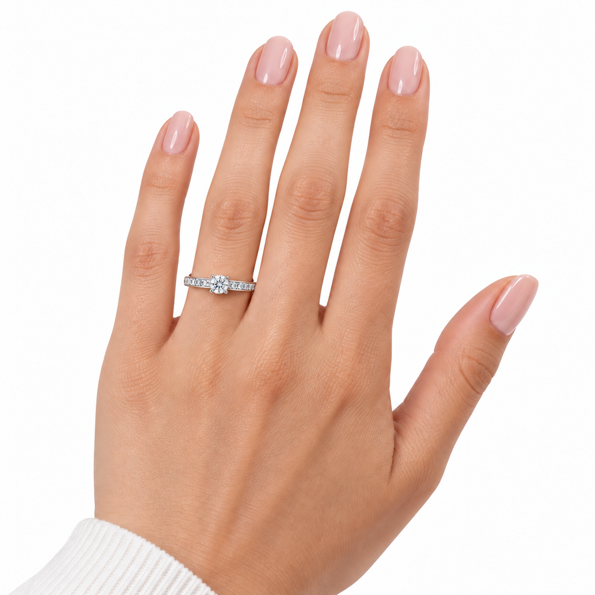 Petite Emma sterling silver solitaire ring worn on a hand with nude pink nails against white