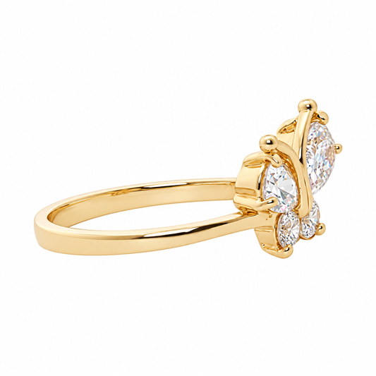 Side view of the Leigh gold butterfly ring with clear cubic zirconia wings and a slim gold band on white.
