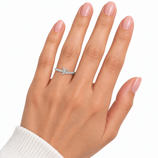 Petite Luna moon and star ring worn on a hand with nude pink nails against white