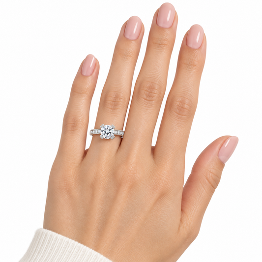 Marla sterling silver solitaire ring worn on a hand with nude pink nails against white