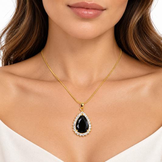 Model wearing Nicole gold black pear halo necklace