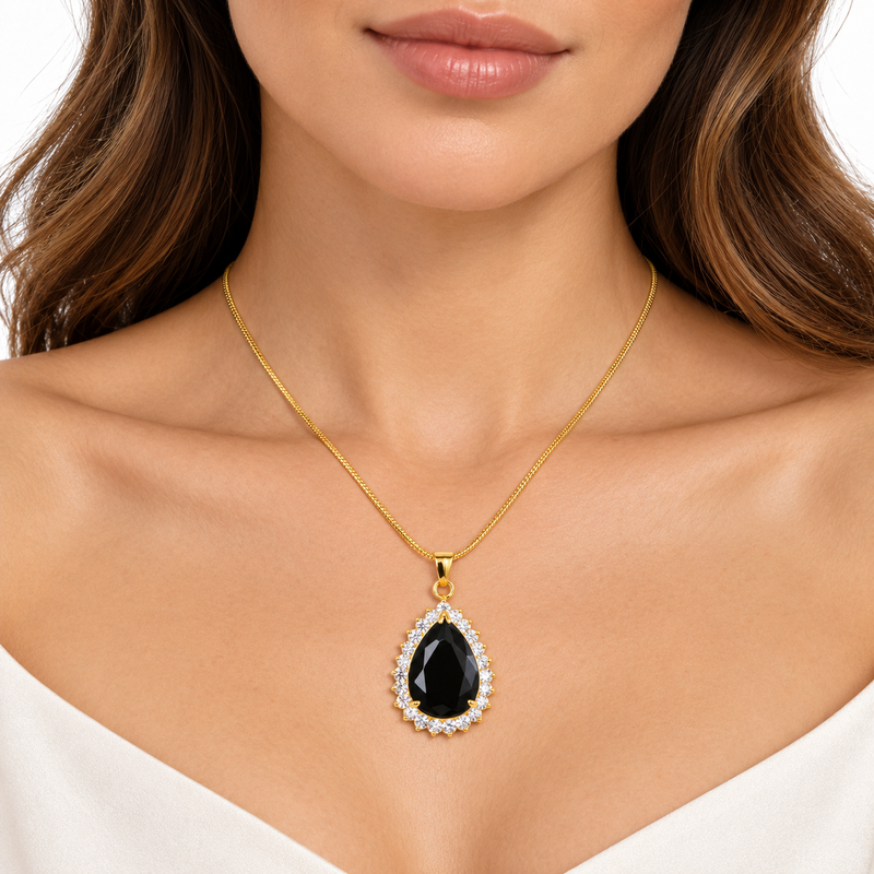 Model wearing Nicole gold black pear halo necklace