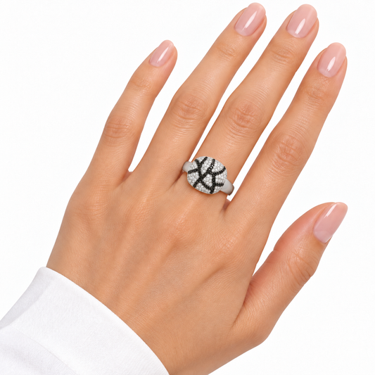 Resili black and clear stone ring worn on a hand with nude pink nails against white