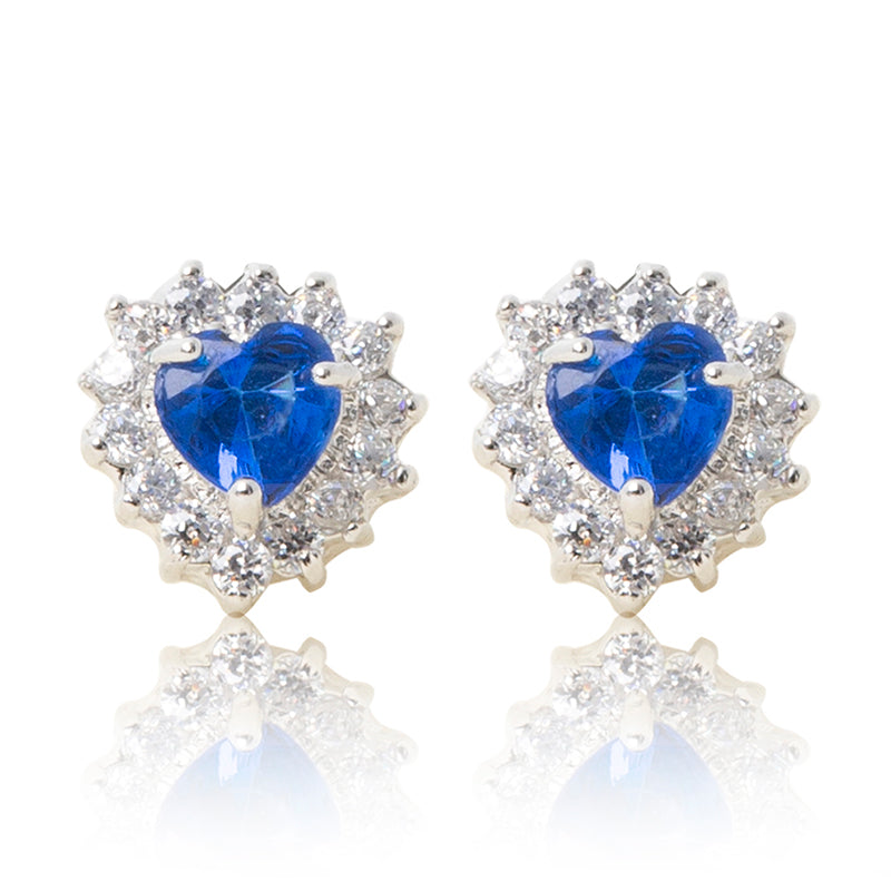 A beautiful tribute to the heart. Delicate rhodium plated studs with clear cubic zirconia stones framing a subtle blue heart stone at the centre. For pierced ears. Side view (Butterfly and pole closure)