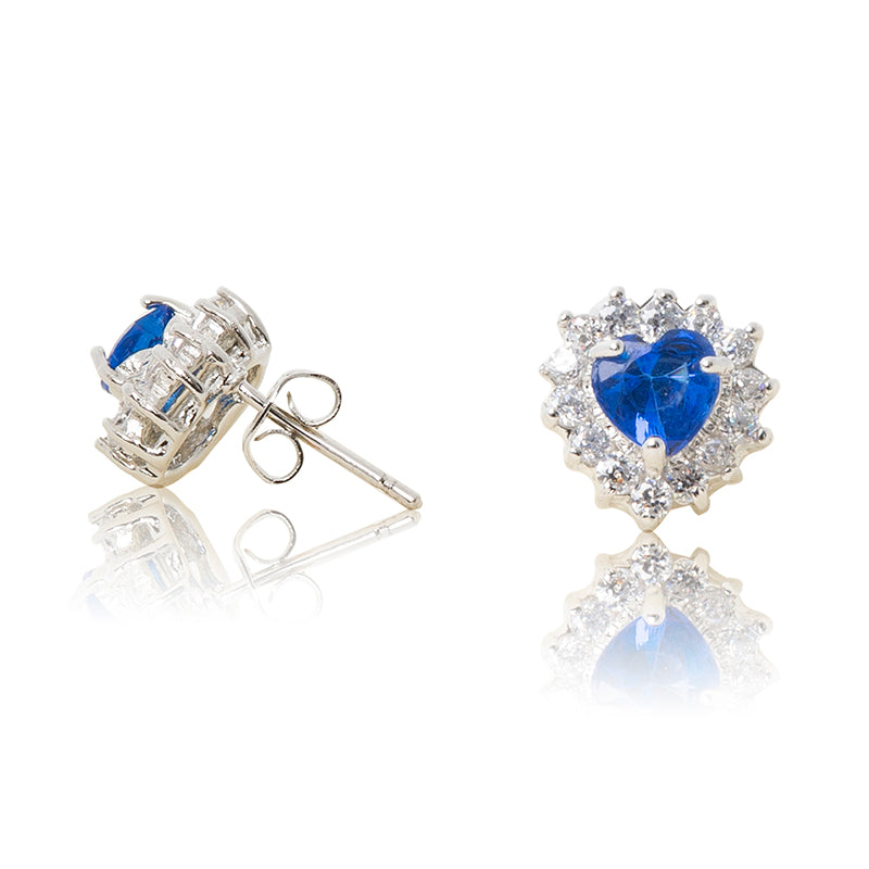 A beautiful tribute to the heart. Delicate rhodium plated studs with cubic zirconia stones framing a subtle blue heart stone at the centre. For pierced ears. Side view (Butterfly and pole closure)