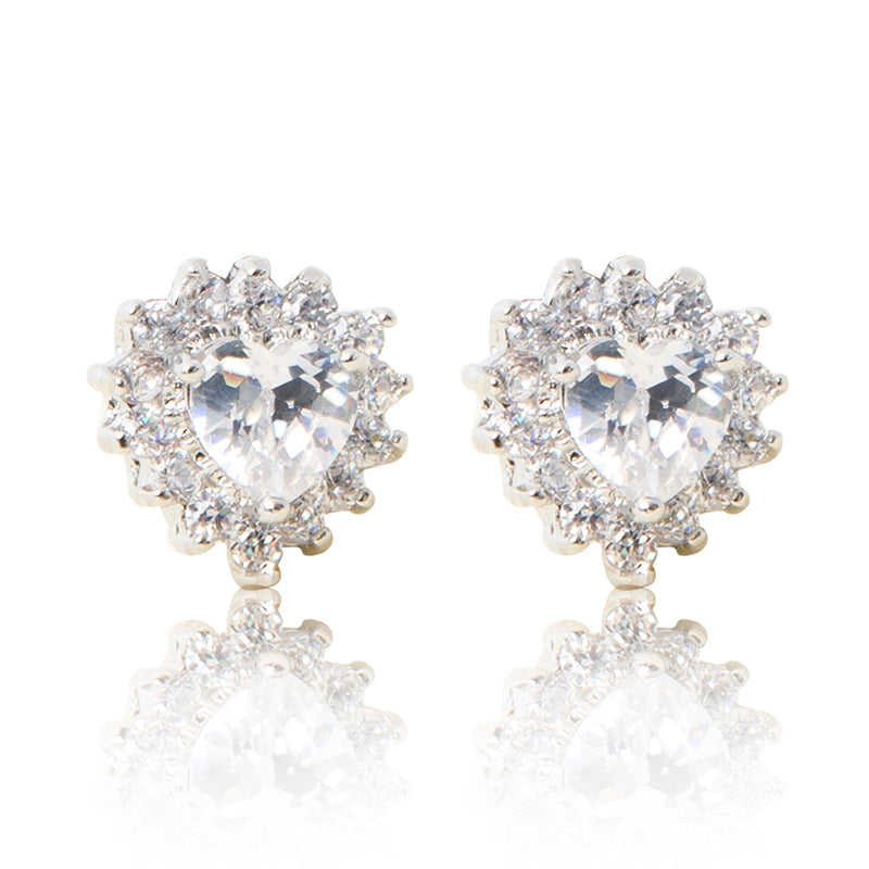 A beautiful tribute to the heart. Delicate rhodium plated studs with cubic zirconia stones framing a subtle clear heart stone at the centre. For pierced ears. 