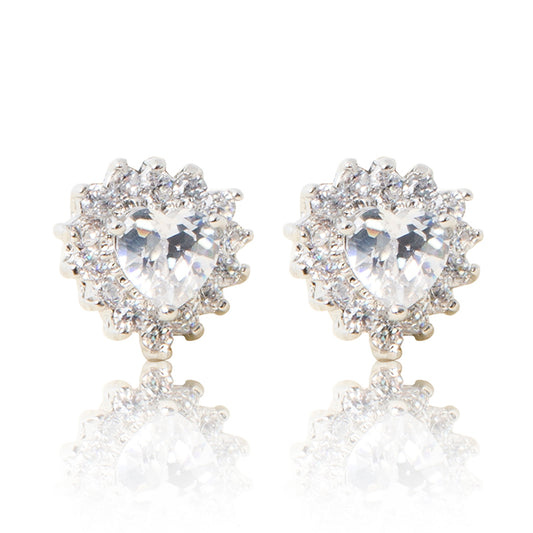 A beautiful tribute to the heart. Delicate rhodium plated studs with cubic zirconia stones framing a subtle clear heart stone at the centre. For pierced ears.