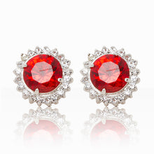 Load image into Gallery viewer, Delicate rhodium plated studs with a red centre surrounded by a halo of cubic zirconia stones. For pierced ears.
