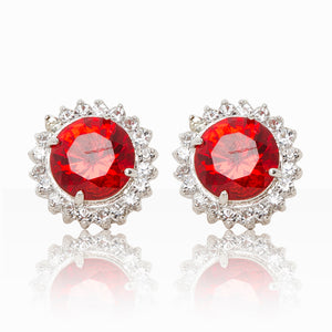 Delicate rhodium plated studs with a red centre surrounded by a halo of cubic zirconia stones. For pierced ears.