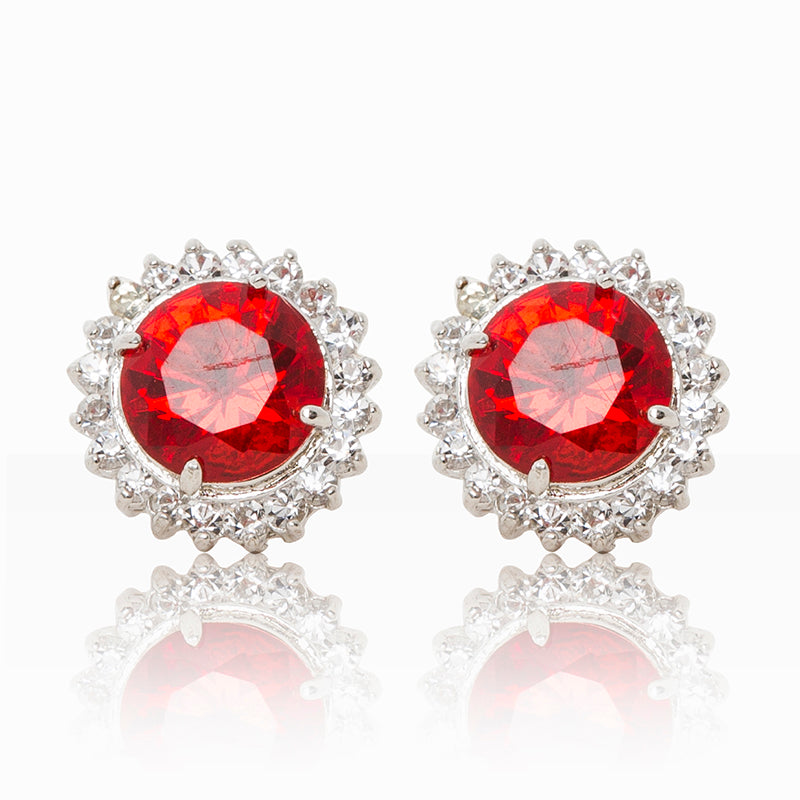 Delicate rhodium plated studs with a red centre surrounded by a halo of cubic zirconia stones. For pierced ears.