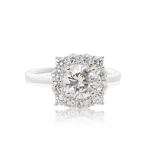 A graceful 925 sterling silver crown halo ring with a round brilliant cubic zirconia centre stone. Front view