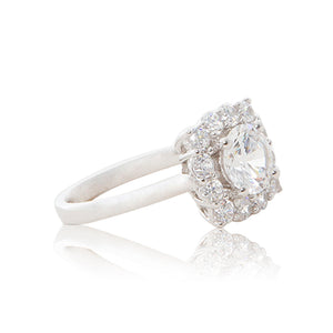 A graceful 925 sterling silver crown halo ring with a round brilliant cubic zirconia centre stone. Side shank view