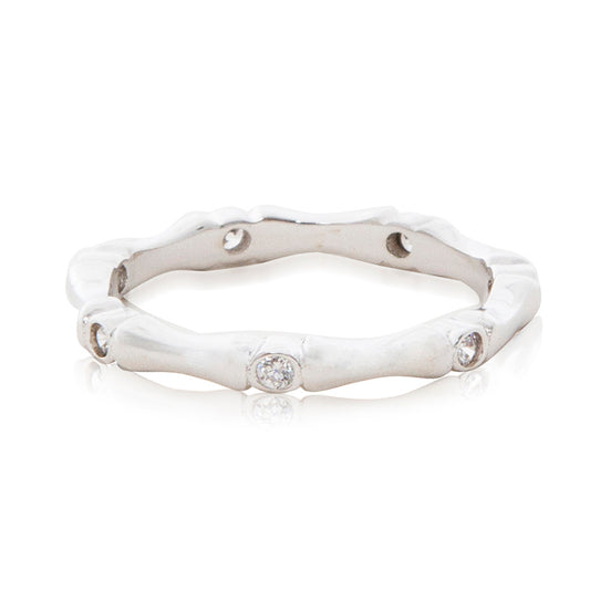 A bamboo inspired rhodium plated ring with cubic zirconia stones in a rub over setting.