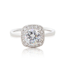 Load image into Gallery viewer, A striking round brilliant cubic zirconia stone surrounded by bead-set cubic zirconia stones evoking a cushion cut guise set in a 925 sterling silver ring.

